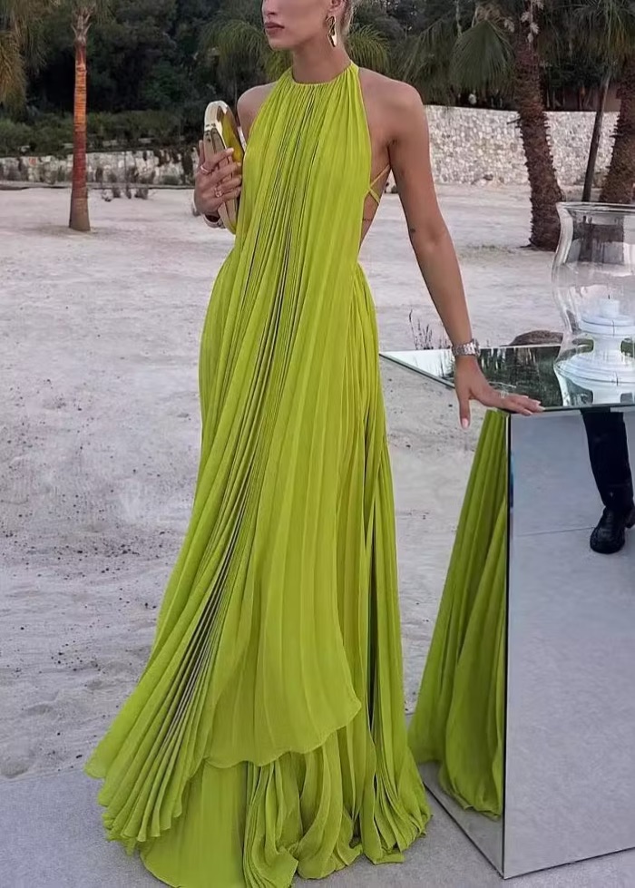 Woman in a chartreuse pleated halter gown